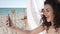 Smiling girl Does selfie on background sea ocean and sand, Selfphoto Young woman on beach, Mobile phone removes holiday