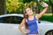 Smiling girl doing selfie on background of car