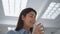 Smiling girl drinking water in office closeup. Happy businesswoman taking sip