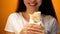 Smiling girl enjoying sandwich, cheap delicious but unhealthy food, close up