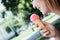 Smiling girl enjoys her strawberry ice cream during a summer day