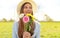 Smiling girl with flowers bouquet looking to the side outdoor in park