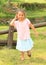 Smiling girl in front wooden swing