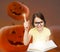 Smiling girl in glasses over pumpkins background