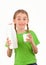 Smiling girl holding a bottle and glass of milk