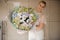 Smiling girl holding a bouquet of white tulips, lilac, orchids and hydrangeas