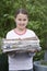 Smiling Girl Holding Bundle Of Waste Paper