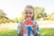 Smiling girl holding watermelon slice in the park