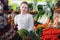 Smiling girl in interior of greengrocery