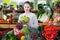 Smiling girl in interior of greengrocery