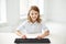 Smiling girl with keyboard at school