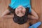 Smiling girl laying on the floor wearing aviator glasses and hat