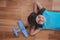 Smiling girl laying on the floor wearing aviator glasses and hat