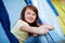 Smiling Girl Looking Up While Sitting In Tent