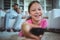 Smiling girl lying on rug and changing channels