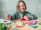 Smiling girl making Christmas felt stocking, Christmas crafting