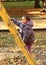 Smiling girl mounting climbing frame