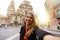 Smiling girl in Murcia taking selfie photo with the Cathedral Church of Saint Mary and cityscape on the background. Girl takes