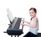 Smiling girl plays on the electric piano.