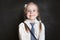 Smiling girl portrait. Happy child schoolgirl on blackboard