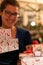 Smiling girl presenting gifts in lovely boxes with bird design at christmas eve