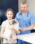 Smiling girl with puppy visiting veterinarian clinic