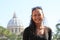 Smiling girl with roof of St. Peter`s Basilica