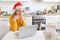 Smiling girl in Santa hat sending air kiss video calling family by webcam. Woman with laptop having virtual meeting chat on