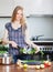 Smiling girl with seabass fish in fryingpan