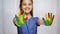 Smiling girl showing painted hands