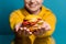 Smiling girl suggests eating a healthy burger without meat and bread, a fruit sandwich