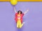 Smiling girl in sunglasses, jumping, holdiing a big balloons, isolated on violet background. Space for text.