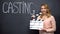 Smiling girl using clapperboard for casting, movie auditions, actor talent