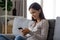 Smiling girl using mobile social media app sitting on couch