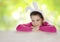 Smiling girl wearing bunny ears at table on abstract background