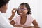 Smiling Girl Wearing Eyeglasses In Front Of Optometrist