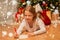 Smiling girl writing christmas wish list at home