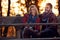 Smiling girlfriend and boyfriend on bench in the park