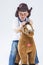 Smiling and Glad Caucasian Little Boy in Cowboy Clothing With Symbolic Plush Horse