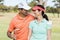 Smiling golfer couple with arm around