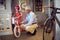 Smiling grandfather and child choosing bicycle in bike shop