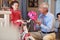Smiling grandfather and child girl choosing bicycle in bike shop