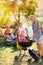 Smiling grandfather and granddaughter grilling barbecue