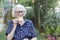 Smiling grandma having cup of coffee outdoors