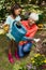 Smiling grandmother and girl watering plants