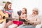 Smiling grandmother with granddaughters singing and playing