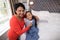 Smiling grandmother helping girl to wear jacket