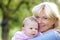 Smiling grandmother holding baby