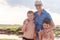 Smiling grandmother hugs two grandchildren