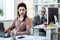 Smiling grey-haired worker attentively looking on his female colleague